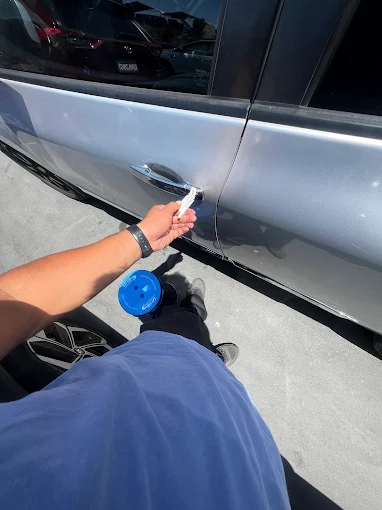 Technician performing an emergency car lockout